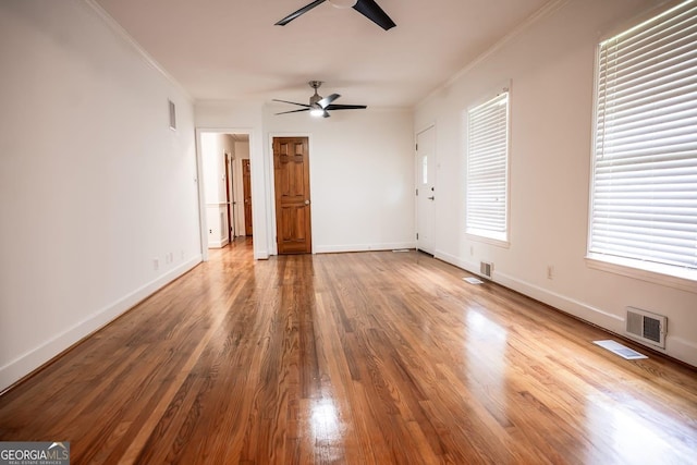 500 Holmes St, Barnesville, GA 30204 - unfurnished living room featuring a ceiling fan, crown molding, and wood finished floors