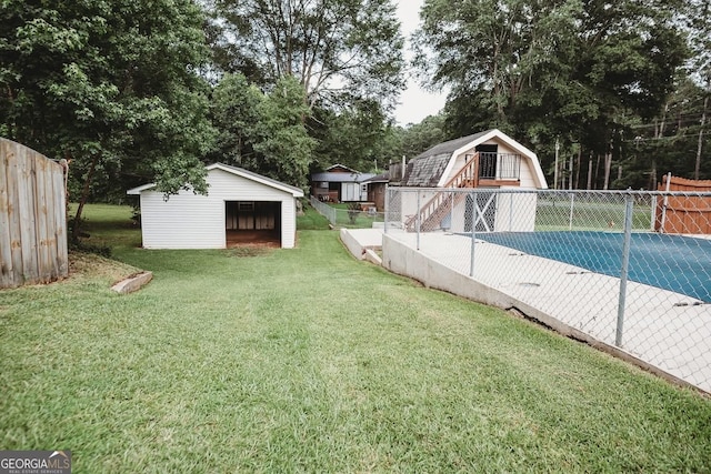 500 Holmes St, Barnesville, GA 30204 - view of yard featuring a garage, a storage shed, and view of wooded area