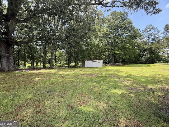 314 Elbert Jackson Rd, Forsyth, GA 31029 - view of grassy yard featuring a storage shed