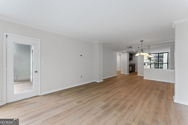 1280 W Peachtree St NW Unit 808, Atlanta, GA 30309 - unfurnished living room with a chandelier, ornamental molding, and light wood-style floors