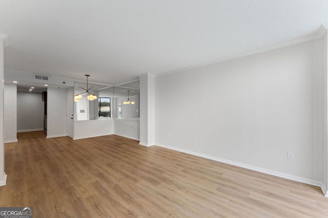 1280 W Peachtree St NW Unit 808, Atlanta, GA 30309 - unfurnished living room featuring light wood-style floors and ornamental molding