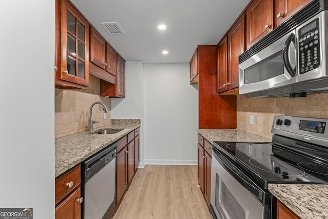 1280 W Peachtree St NW Unit 808, Atlanta, GA 30309 - kitchen featuring appliances with stainless steel finishes, light wood-type flooring, light stone counters, tasteful backsplash, and recessed lighting