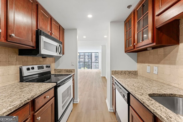1280 W Peachtree St NW Unit 808, Atlanta, GA 30309 - kitchen with stainless steel appliances, tasteful backsplash, light wood-type flooring, light stone countertops, and recessed lighting