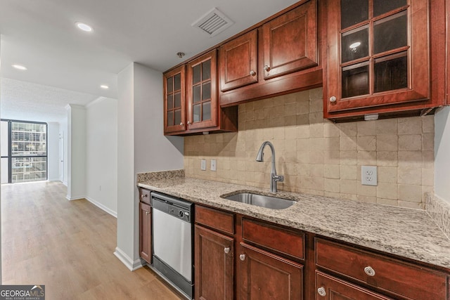 1280 W Peachtree St NW Unit 808, Atlanta, GA 30309 - kitchen with dishwasher, light stone counters, decorative backsplash, light wood-type flooring, and glass insert cabinets