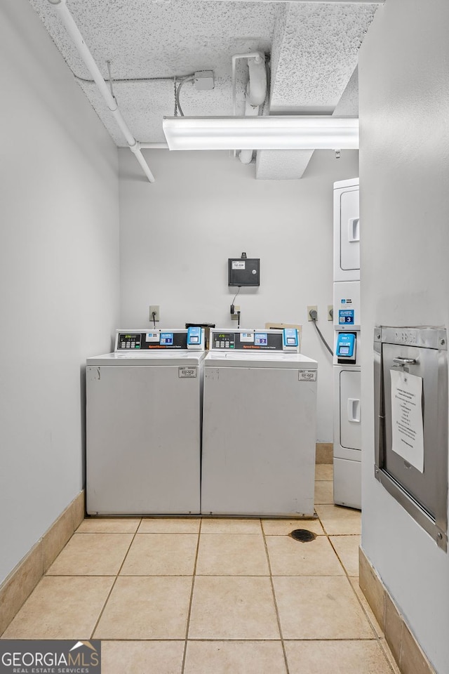 1280 W Peachtree St NW Unit 808, Atlanta, GA 30309 - shared laundry room featuring light tile patterned floors, separate washer and dryer, and stacked washer / dryer