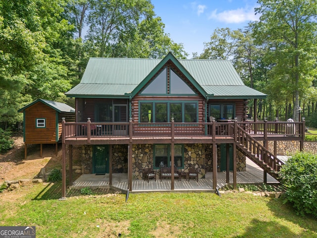 115 Wildcat Run, Suches, GA 30572 - back of property featuring a deck, stone siding, and a yard
