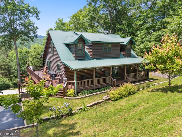 115 Wildcat Run, Suches, GA 30572 - log-style house featuring a front yard, a metal roof, log siding, and covered porch