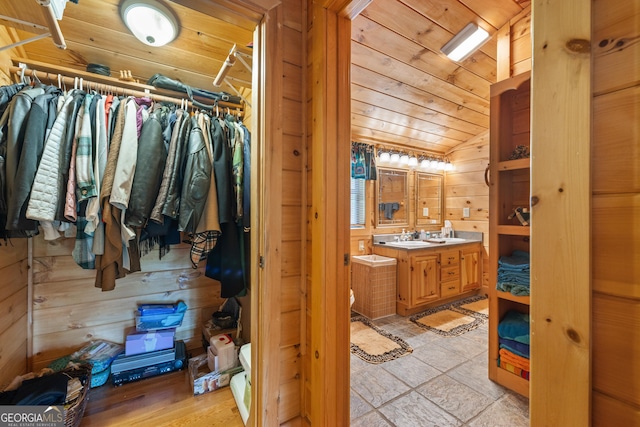 115 Wildcat Run, Suches, GA 30572 - bathroom with vanity, wood walls, wooden ceiling, lofted ceiling, and a walk in closet