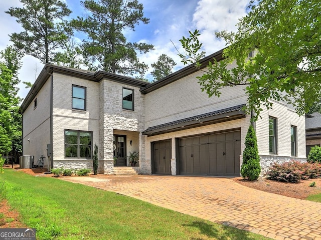 913 Sunny Meadows Ln, Marietta, GA 30062 - view of front facade featuring a front lawn, driveway, brick siding, stone siding, and a standing seam roof