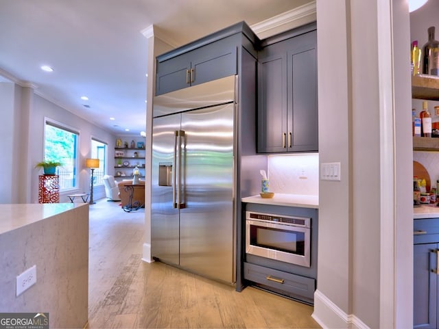 913 Sunny Meadows Ln, Marietta, GA 30062 - kitchen featuring built in appliances, light wood-style floors, crown molding, recessed lighting, and light countertops