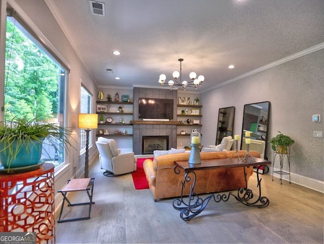 913 Sunny Meadows Ln, Marietta, GA 30062 - living room with wood finished floors, ornamental molding, a chandelier, a tiled fireplace, and recessed lighting
