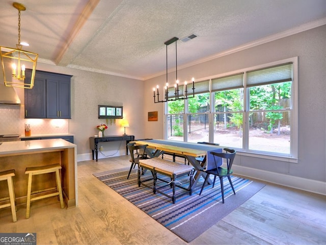 913 Sunny Meadows Ln, Marietta, GA 30062 - dining room featuring a chandelier, crown molding, light wood-style floors, and a textured ceiling