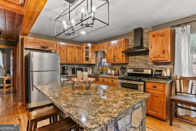 230 Grove Ln Unit 3642, Ellijay, GA 30540 - kitchen featuring stainless steel appliances, wall chimney exhaust hood, light wood-type flooring, dark stone counters, and brown cabinetry