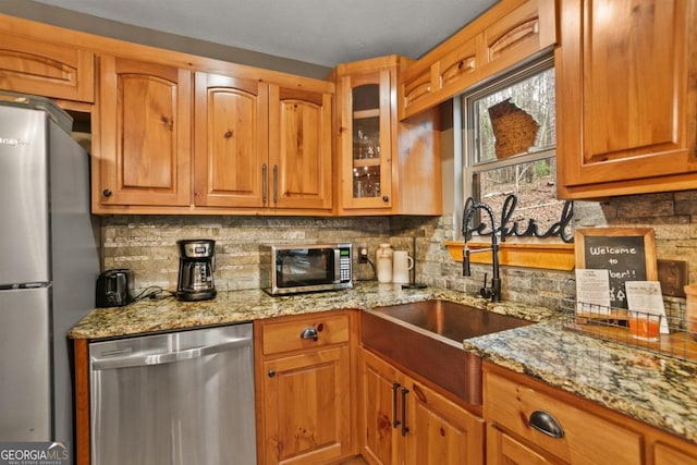 230 Grove Ln Unit 3642, Ellijay, GA 30540 - kitchen with stainless steel appliances, light stone counters, decorative backsplash, glass insert cabinets, and brown cabinetry