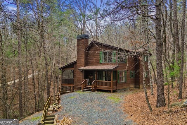 230 Grove Ln Unit 3642, Ellijay, GA 30540 - rustic home with a chimney, a wooded view, and covered porch