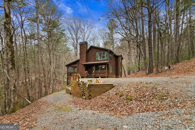 230 Grove Ln Unit 3642, Ellijay, GA 30540 - view of front of property featuring a chimney, a wooden deck, and a forest view