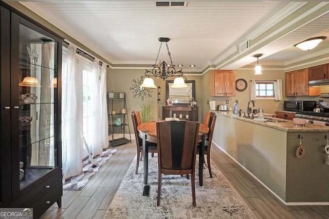 1313 Old Countryside Cir, Stone Mountain, GA 30083 - dining area featuring light wood-style flooring and ornamental molding