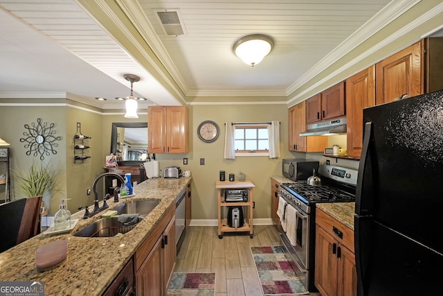 1313 Old Countryside Cir, Stone Mountain, GA 30083 - kitchen with stainless steel appliances, under cabinet range hood, light wood-type flooring, light stone counters, and brown cabinets