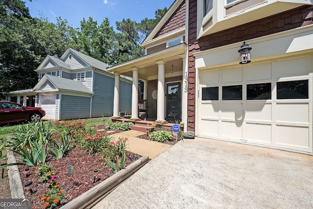 1313 Old Countryside Cir, Stone Mountain, GA 30083 - view of exterior entry with concrete driveway and a porch
