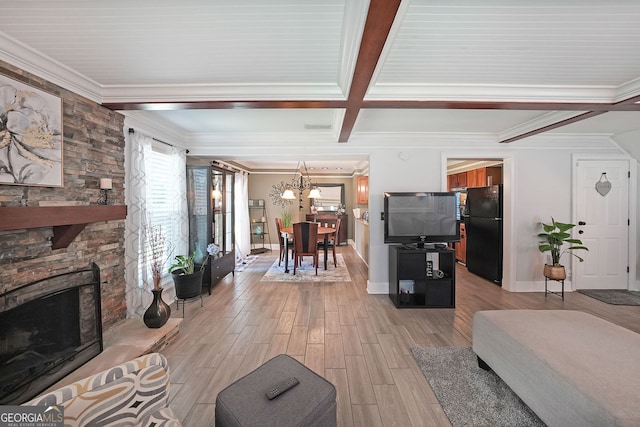 1313 Old Countryside Cir, Stone Mountain, GA 30083 - living area with crown molding, a chandelier, light wood-style flooring, beamed ceiling, and a stone fireplace