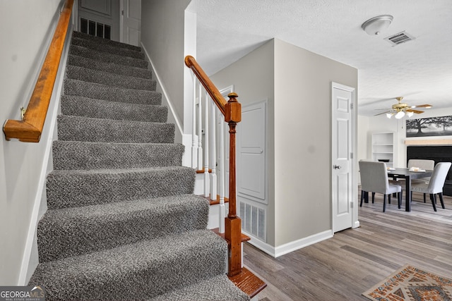 106 Ivy Ct, Lagrange, GA 30241 - stairs with ceiling fan, wood finished floors, and a textured ceiling