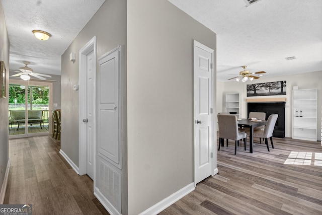 106 Ivy Ct, Lagrange, GA 30241 - hallway featuring a textured ceiling, wood finished floors, and an office area