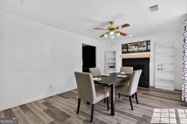 106 Ivy Ct, Lagrange, GA 30241 - dining room with a ceiling fan, wood finished floors, a fireplace, and a textured ceiling