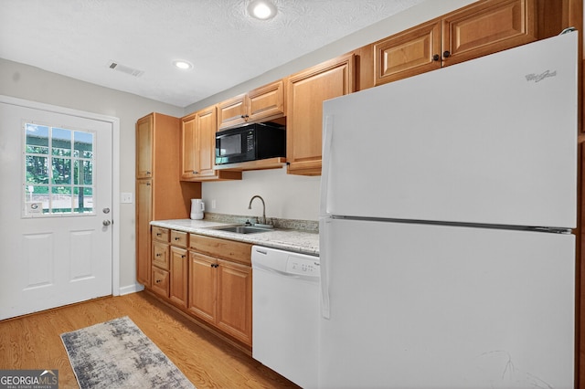 106 Ivy Ct, Lagrange, GA 30241 - kitchen with white appliances, light countertops, light wood-style floors, recessed lighting, and brown cabinetry