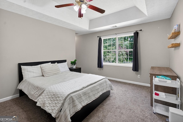 106 Ivy Ct, Lagrange, GA 30241 - carpeted bedroom with a tray ceiling, a ceiling fan, and a textured ceiling