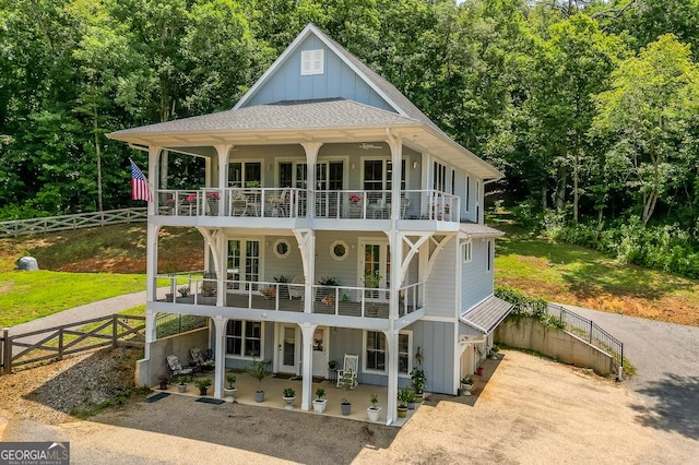 682 Tanglewood Ln, Ellijay, GA 30540 - view of front of house with a balcony, board and batten siding, driveway, and a patio