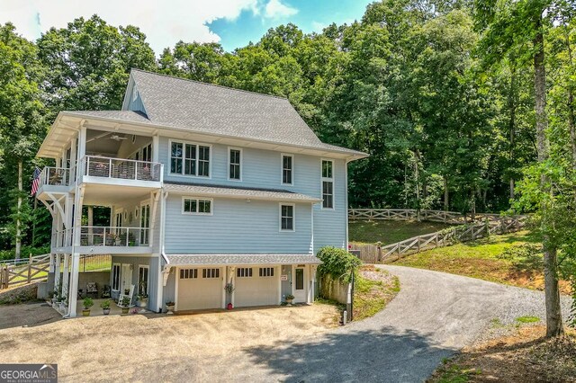 682 Tanglewood Ln, Ellijay, GA 30540 - view of front facade with a balcony, driveway, an attached garage, and roof with shingles