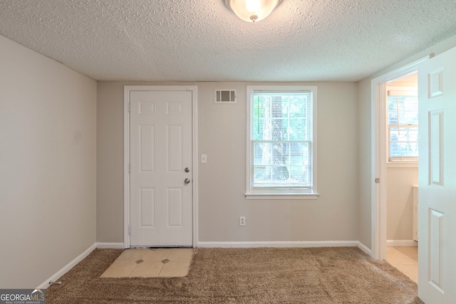 3110 Ashly Cove Ln, Snellville, GA 30078 - foyer featuring light colored carpet and a textured ceiling