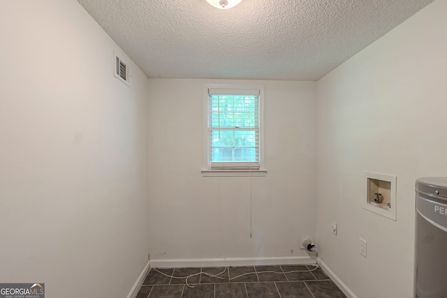 3110 Ashly Cove Ln, Snellville, GA 30078 - laundry area featuring washer hookup, dark tile patterned floors, and a textured ceiling