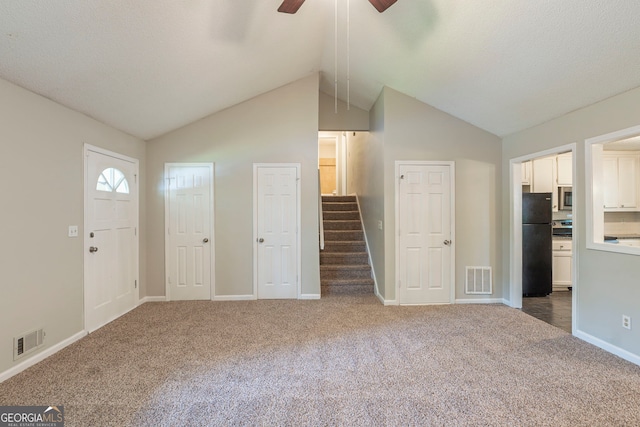 3110 Ashly Cove Ln, Snellville, GA 30078 - unfurnished living room featuring a ceiling fan, carpet, and lofted ceiling
