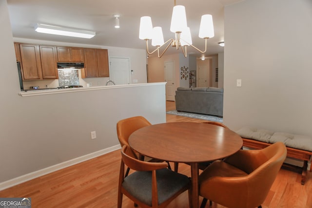 691 Walnut Woods Dr, Braselton, GA 30517 - dining room featuring light wood-type flooring and a chandelier