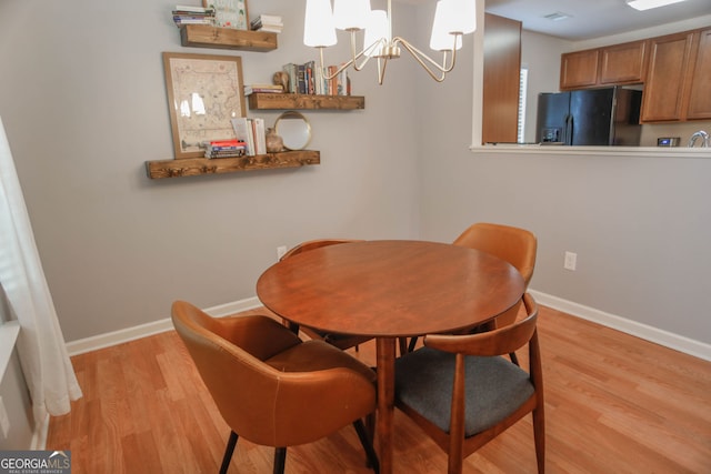 691 Walnut Woods Dr, Braselton, GA 30517 - dining room featuring light wood-style floors and a chandelier