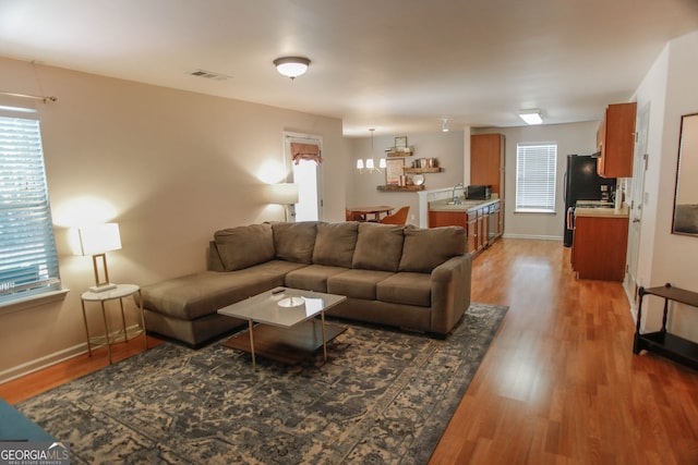 691 Walnut Woods Dr, Braselton, GA 30517 - living room with light wood-style flooring and healthy amount of natural light