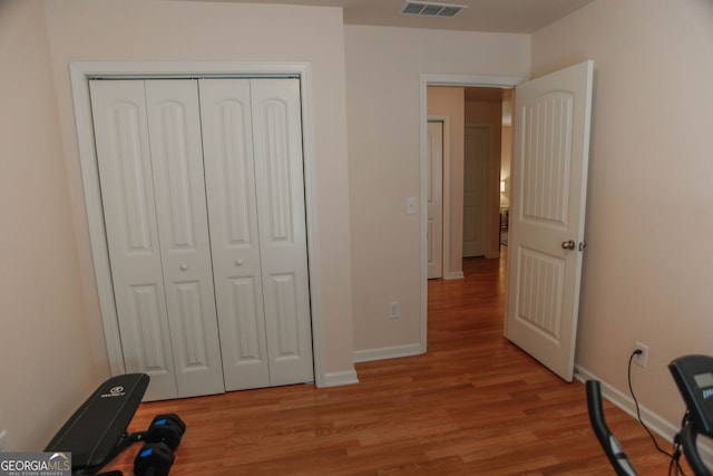 691 Walnut Woods Dr, Braselton, GA 30517 - bedroom featuring light wood-type flooring and a closet