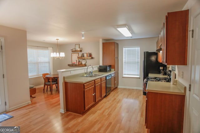 691 Walnut Woods Dr, Braselton, GA 30517 - kitchen featuring brown cabinetry, black appliances, a peninsula, and light countertops