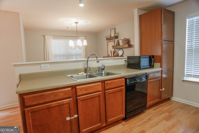 691 Walnut Woods Dr, Braselton, GA 30517 - kitchen with black appliances, light wood-type flooring, and light countertops