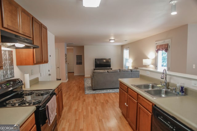 691 Walnut Woods Dr, Braselton, GA 30517 - kitchen with black appliances, under cabinet range hood, light countertops, and light wood-type flooring