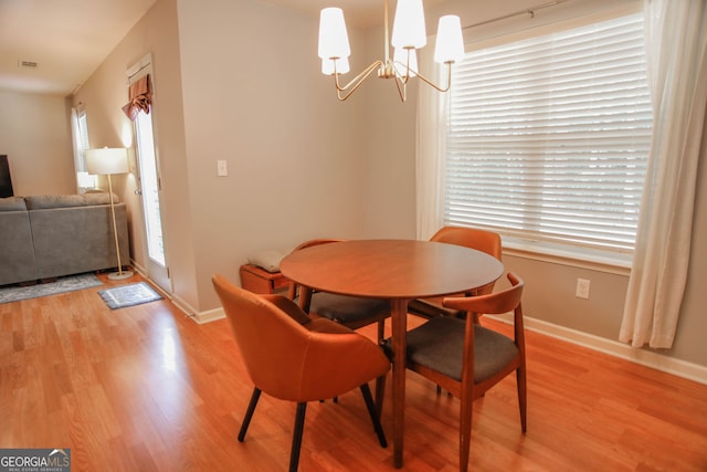 691 Walnut Woods Dr, Braselton, GA 30517 - dining area with light wood-style flooring and a chandelier