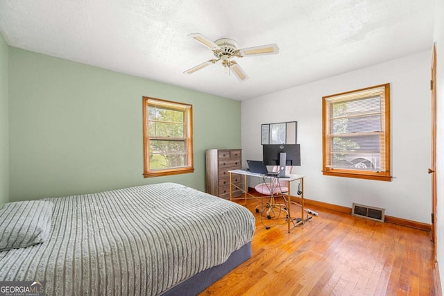 135 5th Ave, Jonesboro, GA 30236 - bedroom with wood-type flooring and ceiling fan