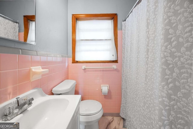 135 5th Ave, Jonesboro, GA 30236 - full bath with tile walls, vanity, a shower with shower curtain, and wainscoting