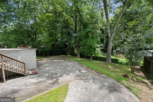 135 5th Ave, Jonesboro, GA 30236 - view of yard with stairs and view of wooded area