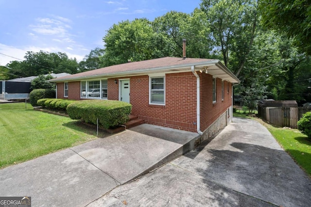 135 5th Ave, Jonesboro, GA 30236 - ranch-style house with brick siding, a front yard, and driveway