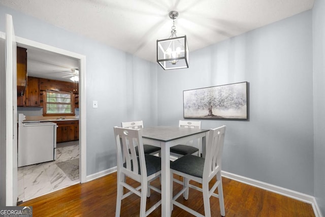 135 5th Ave, Jonesboro, GA 30236 - dining space with a chandelier, ceiling fan, and wood finished floors