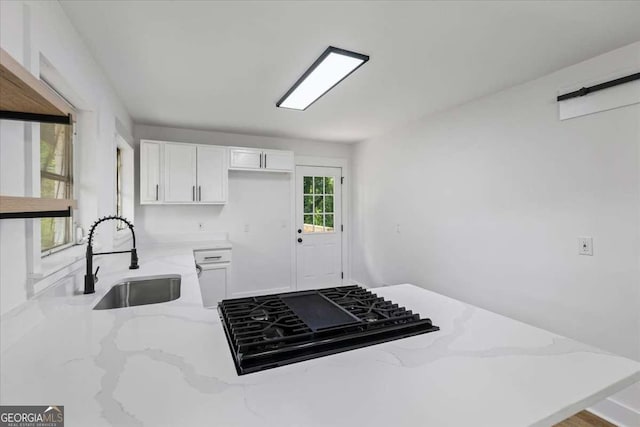 1400 N Ave NW, Atlanta, GA 30318 - kitchen with black gas cooktop, light stone countertops, and white cabinets