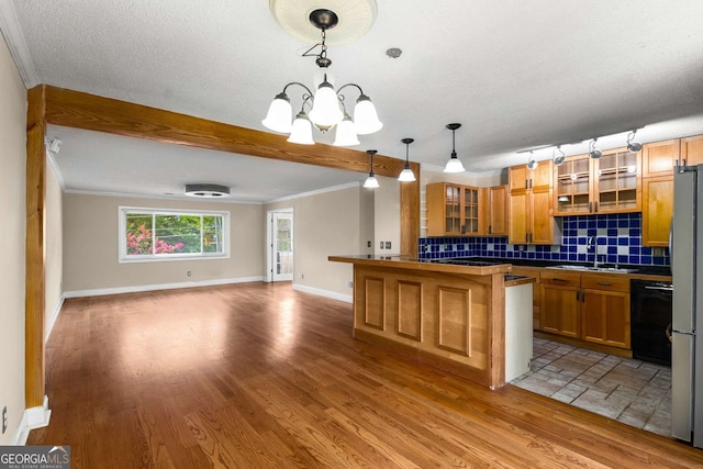 115 Biscayne Dr NW Unit E3, Atlanta, GA 30309 - kitchen with open floor plan, decorative backsplash, a chandelier, wood finished floors, and glass insert cabinets