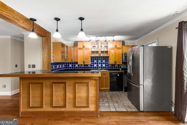 115 Biscayne Dr NW Unit E3, Atlanta, GA 30309 - kitchen featuring appliances with stainless steel finishes, a peninsula, tasteful backsplash, glass insert cabinets, and decorative light fixtures